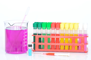 Set of chemical test tubes, syringe and beaker with permanganate