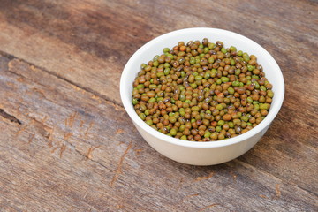 mung bean in white bowl on wooden background