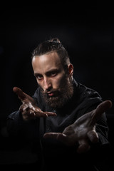 Studio portrait of a handsome man with a beard practicing kung fu