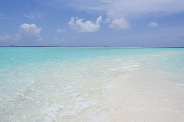 Tropical sand beach and blue sky with white clouds