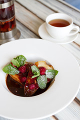 Pear in chocolate in a large plate