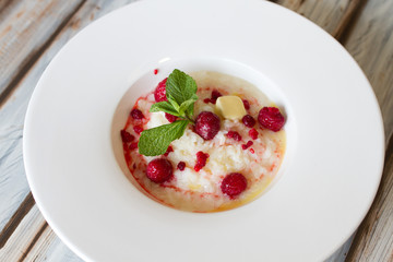 Boiled rice with raspberry in a large plate