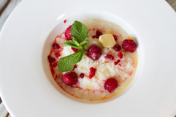 Boiled rice with raspberry in a large plate