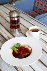Pear in chocolate in a large plate