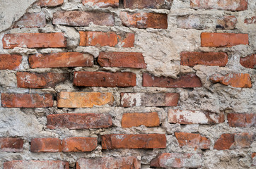 Background of old vintage dirty brick wall with peeling plaster texture