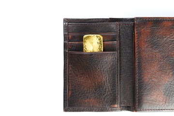 Gold bar put in the leather wallet represent business concept.