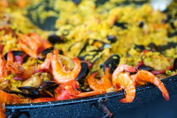 Paella with pink prawns and other seafood
