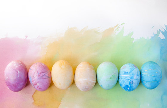 Watercolor background with colorful rainbow Easter eggs