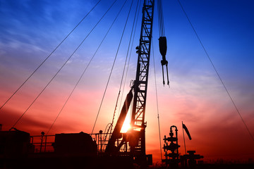 Pumping unit in the work, under the background of the setting sun