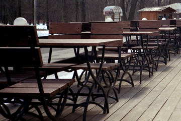 A summer cafe is waiting for visitors. Early spring, park.