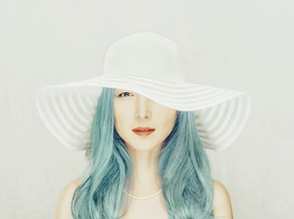Beautiful woman with blue hair in a hat.
