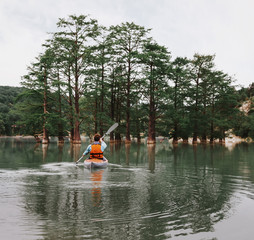 Young man kayaking on lake