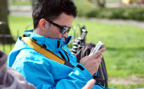 Asian tourist man connecting pocket wifi to smart phone while on trip traveling