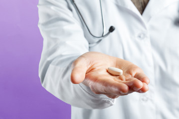 Doctor holding pills