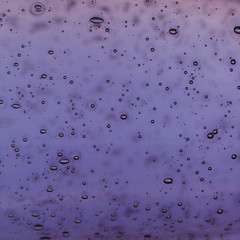 Abstract drops on purple glass background