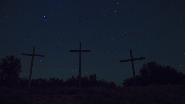 Night time lapse of 3 crosses and stars
