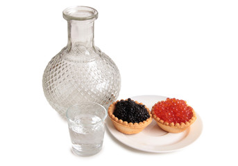 Fish caviar and glass of vodka on white background