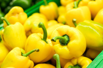 Fresh yellow organic sweet bell peppers on the farmer market on a tropical island Bali, Indonesia. Organic background.