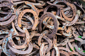 Large pile of rusty used Horseshoes