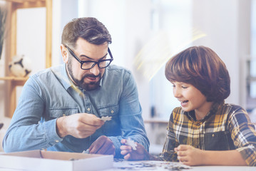 Father and son joking while playing chass