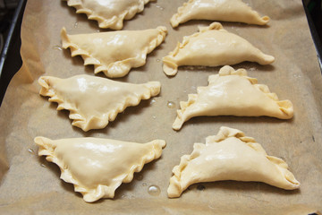 Preparation of pies with cabbage and spices.