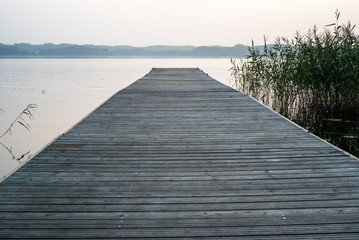 wooden pier on the river seashore