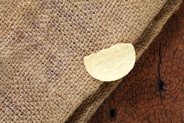 Potato chips put on the sack surface.