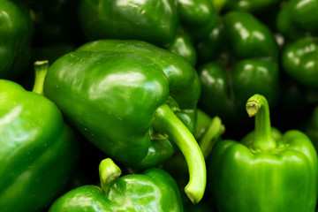 Fresh green organic sweet bell peppers on the farmer market on a tropical island Bali, Indonesia. Organic background.