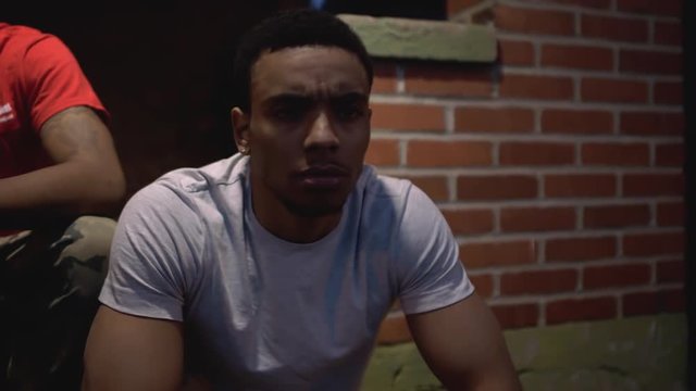 Young African American Male Sitting on Front Porch Steps