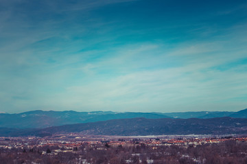 Photo depicting a beautiful moody frosty landscape. European alpine mountains with snow peaks on a blue sky background.