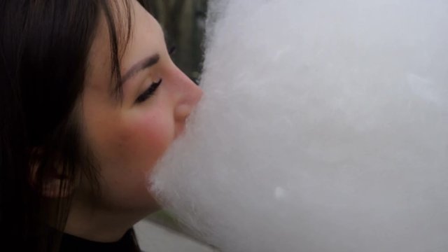 Funny Brunette Eat Cotton Candy In The Park