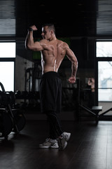 Fototapeta na wymiar Handsome Man Flexing Muscles