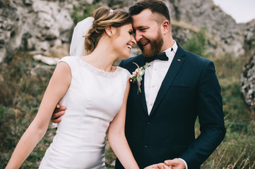 portrait of a girl and couples looking for a wedding dress, a pink dress flying with a wreath of flowers on her head on a background tsvetu chicago garden and the blue sky, and they hug and pose