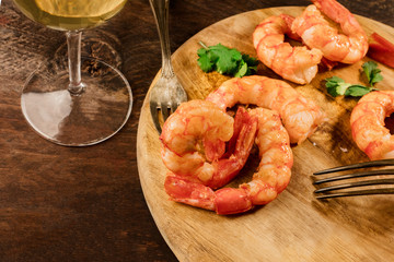 Cooked shrimps with a glass of white wine and copyspace