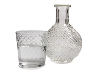 Vodka in a glass and decanter on a white background