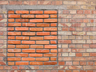 Immured bricked-up window on an old brick wall