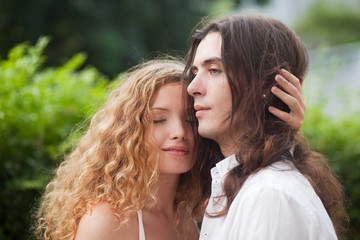 young beautiful couple long haired nature