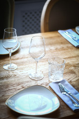 Fork and knife on a table, near a plate