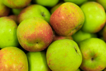 Background of apples on sale at the local organic market of tropical Bali island, Indonesia.