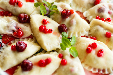 Sweet boiled dumplings with cherries and berries