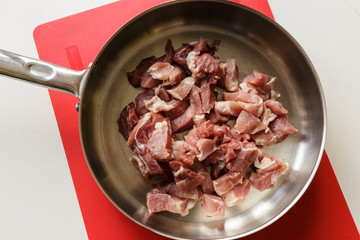 Pork in a hot steel frying pan