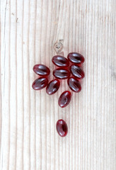 Pile of capsules Omega 3 on wood background. Close up, top view