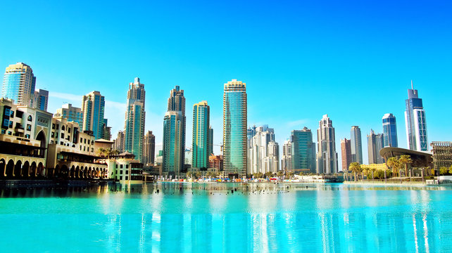 Downtown Dubai skyline, panoramic view from the Dubai fountain. Modern city cityscape with skyscrapers, sunny day.
