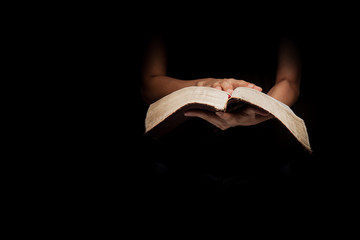 A woman reading the Holy Bible.
