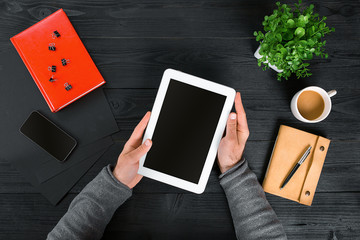 Directly above view of human hands with digital tablet.