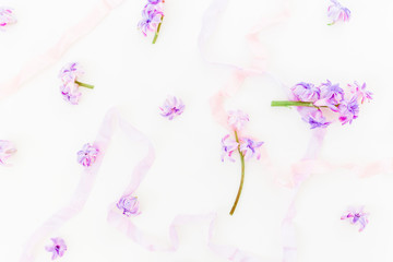 Pattern of pink hyacinth, petals and tapes isolated on white background. Flat lay, top view.