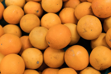 Fresh oranges on a local organic farm market on a tropical Bali island, Indonesia. Oranges background.