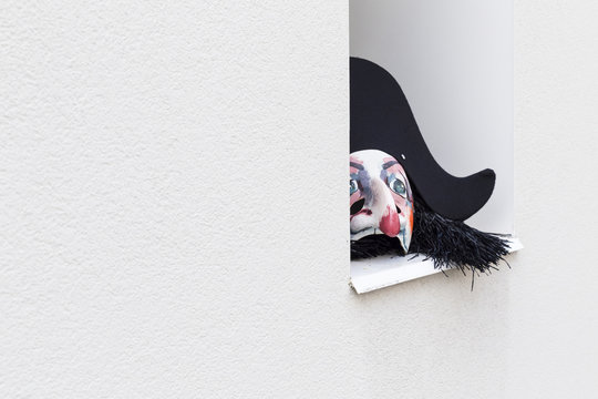 Basel carnival. Nadelberg, Basel, Switzerland - March 7, 2017. A single carnival mask with black hat laying on a window sill.