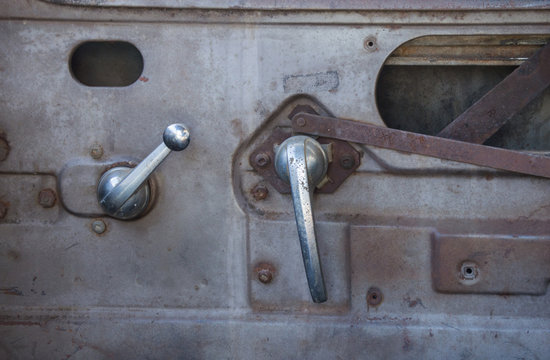 The Inside Door Of An Old Farm Truck With Old Fashioned Crank Windows