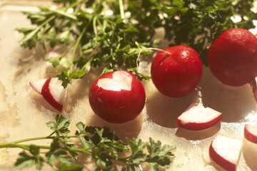 
Red radish on a kitchen board with a cut in the shape of a heart